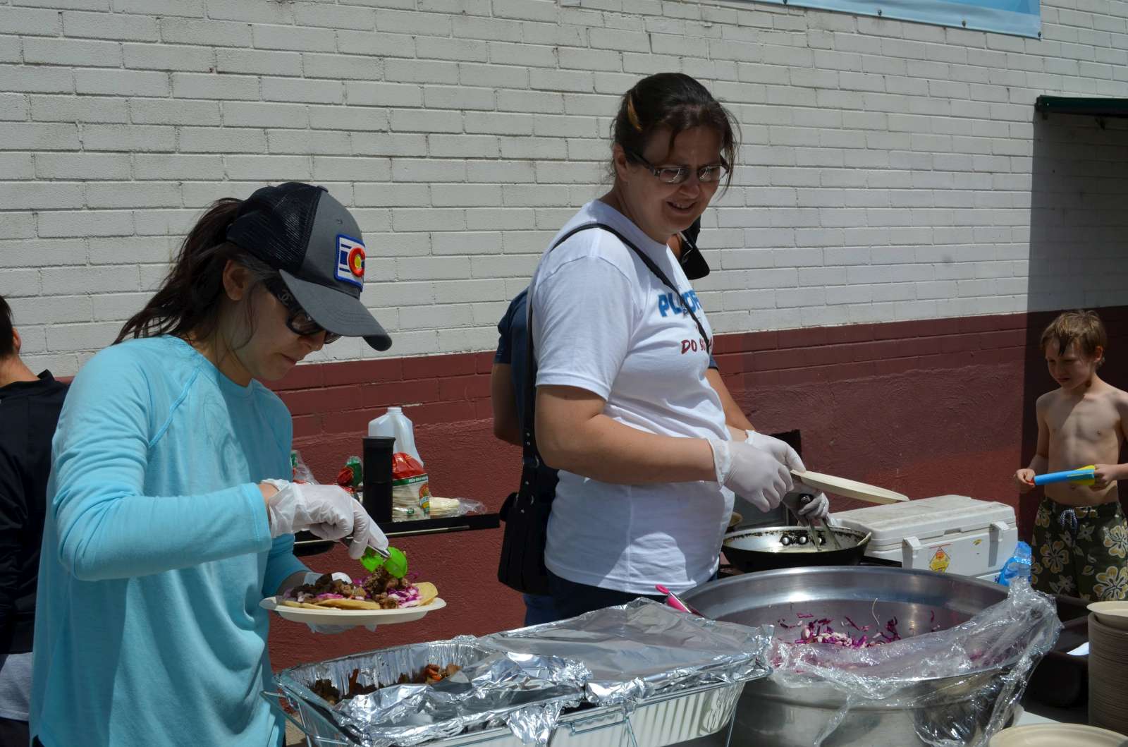 Hwa Jeong and Natasha serving the food